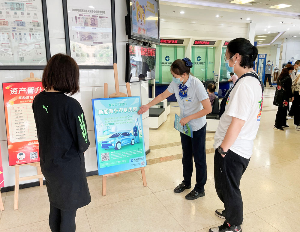2建行网点员工为客户介绍新能源购车分期活动.jpg